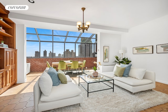 living room featuring a chandelier, a view of skyline, and brick wall