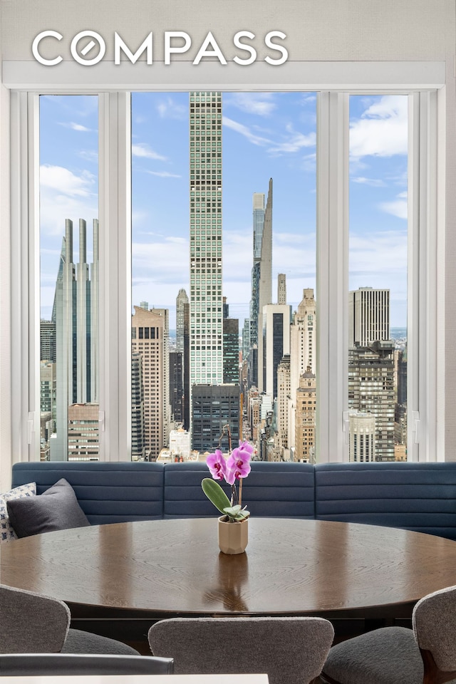 252 E 57th St Unit 60A, New York City, NY 10022 - dining area featuring a skyline view and plenty of natural light
