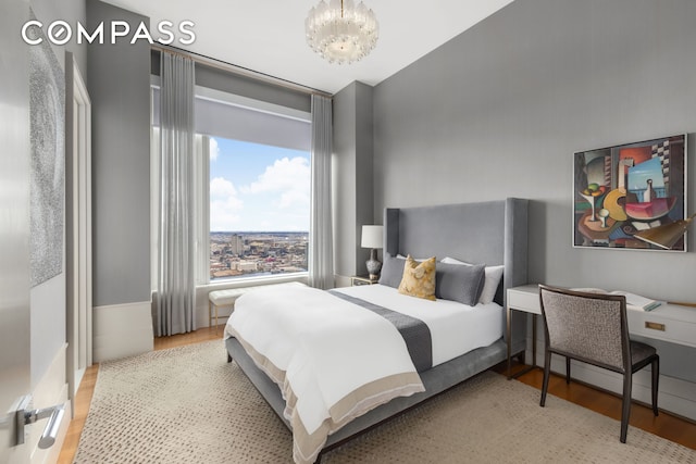 252 E 57th St Unit 60A, New York City, NY 10022 - bedroom with a chandelier and wood finished floors