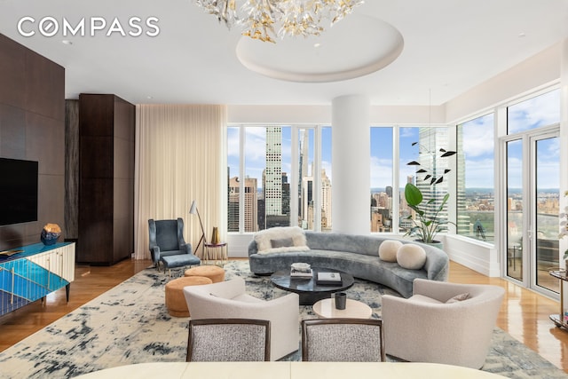 252 E 57th St Unit 60A, New York City, NY 10022 - living room with a chandelier, wood finished floors, and a view of city