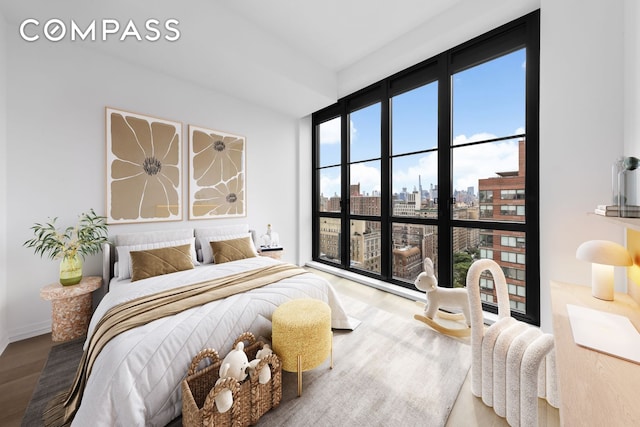 250 W 96th St Unit 21C, New York City, NY 10025 - bedroom with wood finished floors, a view of city, and expansive windows