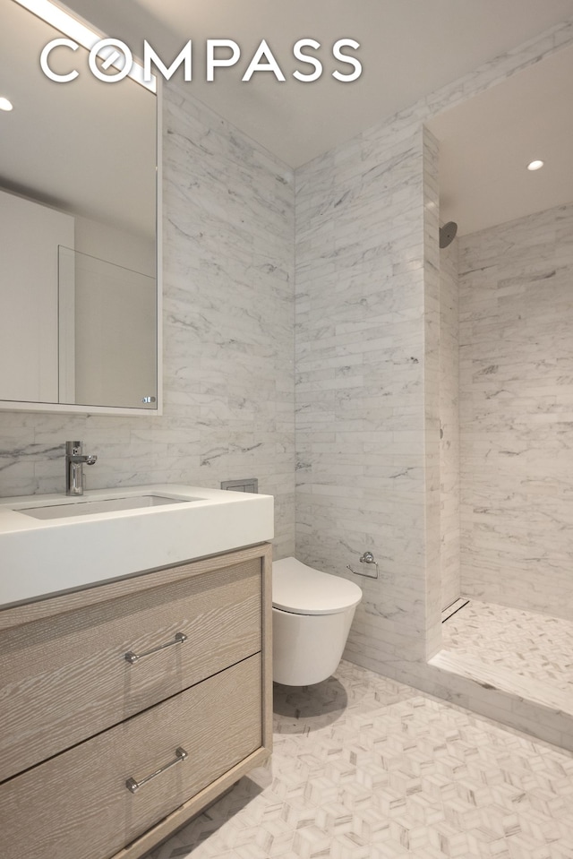 full bath featuring tile walls, tiled shower, vanity, toilet, and recessed lighting