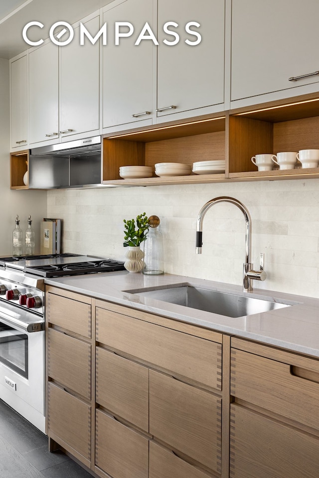250 W 96th St Unit 21C, New York City, NY 10025 - kitchen featuring open shelves, a sink, stainless steel stove, decorative backsplash, and light countertops