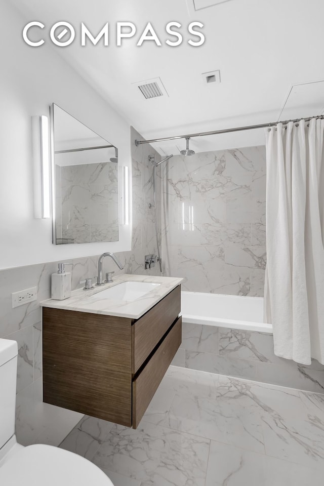 325 Lexington Ave Unit 16C, New York City, NY 10016 - bathroom with toilet, vanity, marble finish flooring, and a combined bath / shower with marble appearance