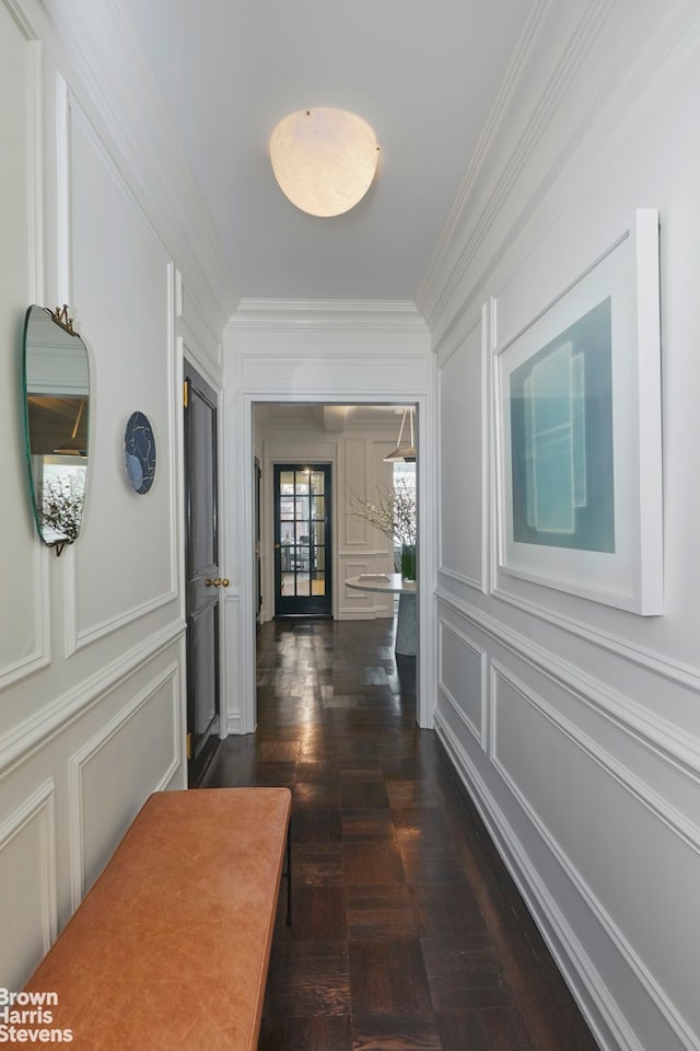 hallway with a decorative wall and ornamental molding
