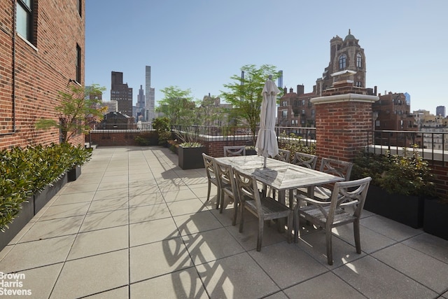 view of patio featuring a city view and outdoor dining area