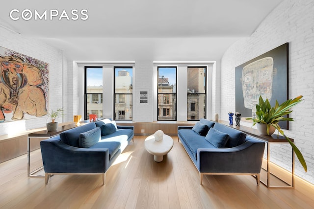 543 Broadway Unit 6, New York City, NY 10012 - living room with wood finished floors and brick wall