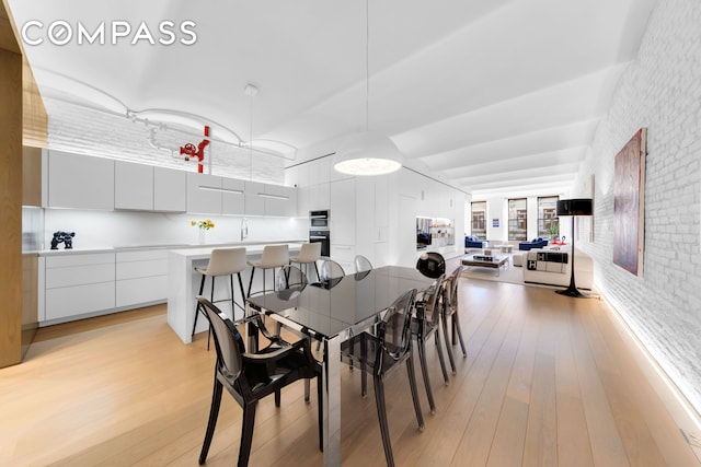 dining area with light wood-style flooring