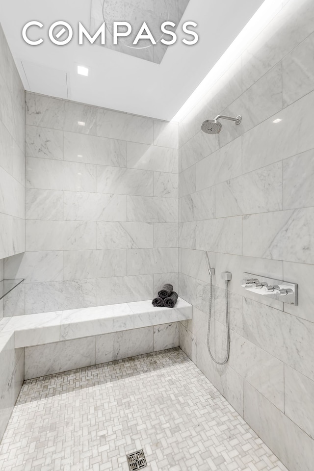 bathroom featuring a tile shower and recessed lighting