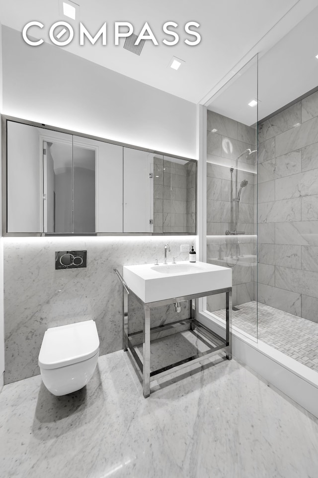 full bath with walk in shower, a sink, toilet, and tile walls