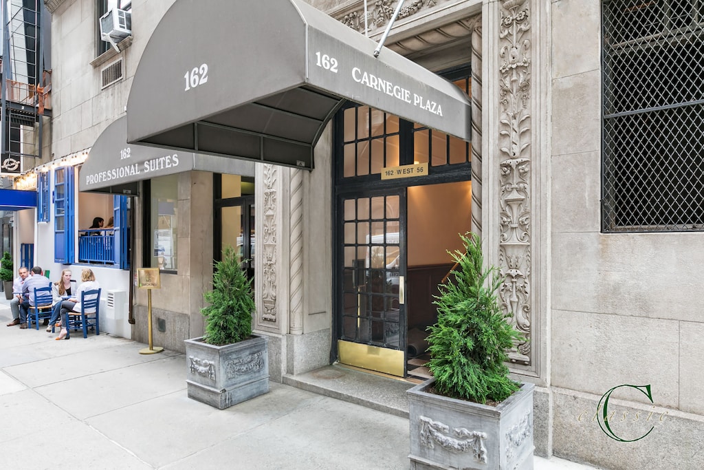 162 W 56th St Unit 1202, New York City, NY 10019 - view of exterior entry with stone siding and cooling unit
