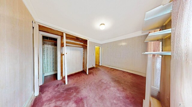 unfurnished bedroom featuring carpet and baseboards