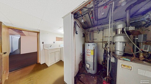 utilities featuring a sink and gas water heater