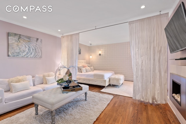61 Oliver St Unit 4P, New York City, NY 11209 - living room featuring wood finished floors, recessed lighting, a fireplace, and ornamental molding