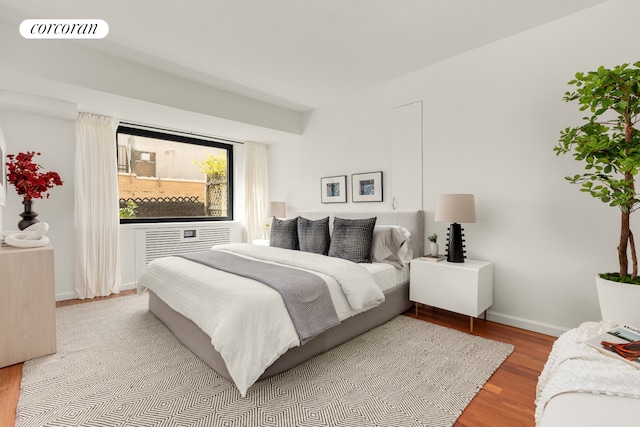bedroom featuring wood finished floors and baseboards