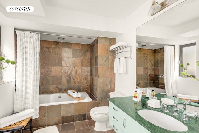 full bathroom featuring tiled shower / bath combo, vanity, and toilet