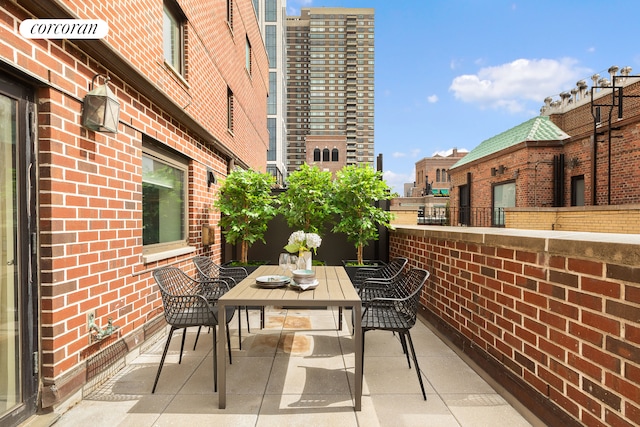balcony featuring outdoor dining space and a patio area