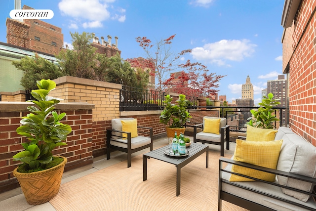 balcony featuring a view of city, outdoor lounge area, and a patio area