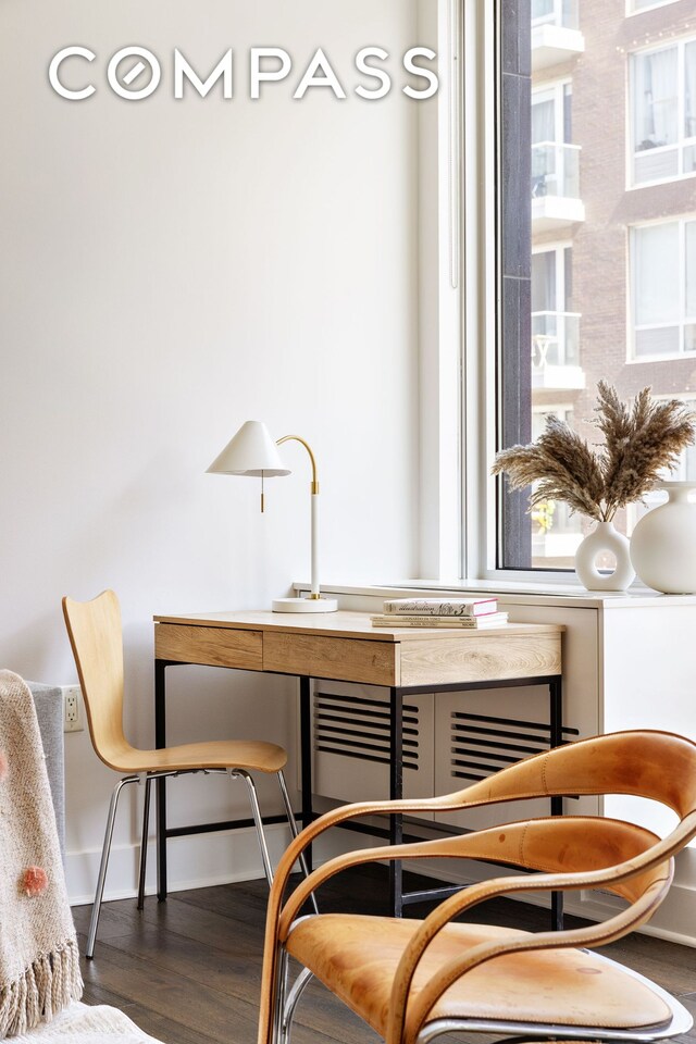 dining space with wood finished floors and baseboards