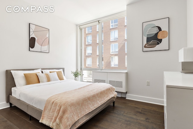 bedroom featuring baseboards and dark wood-style floors