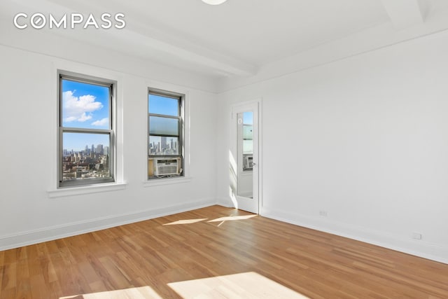 empty room featuring light wood-style floors and baseboards