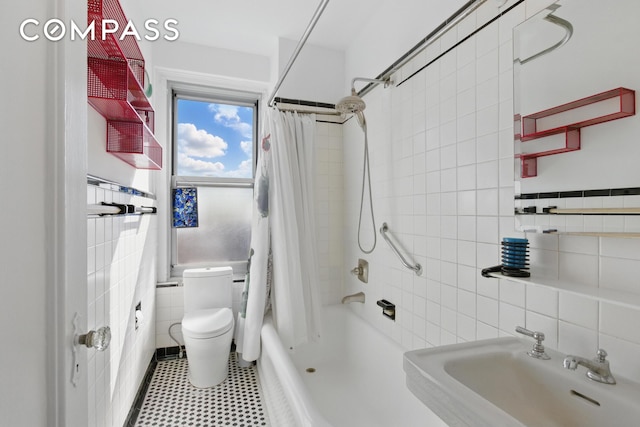 1 Plaza St W Unit 12C, New York City, NY 11217 - bathroom featuring tile walls, a sink, shower / tub combo with curtain, toilet, and tile patterned floors