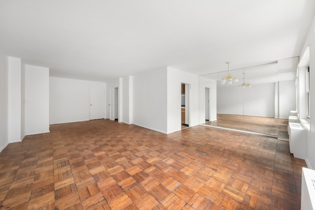 20 E 9th St Unit 2X, New York City, NY 10003 - spare room with a chandelier and baseboards