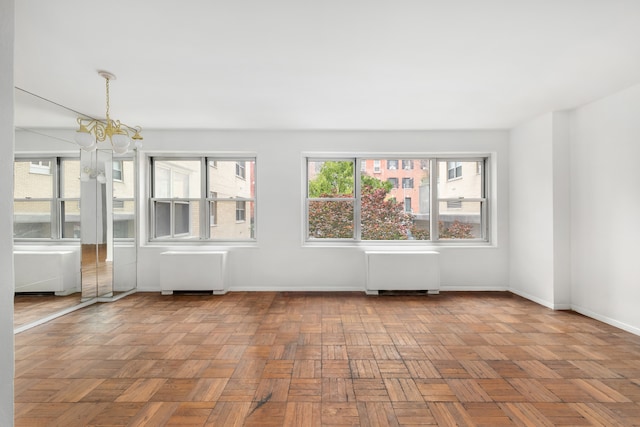 20 E 9th St Unit 2X, New York City, NY 10003 - unfurnished room featuring radiator and a chandelier