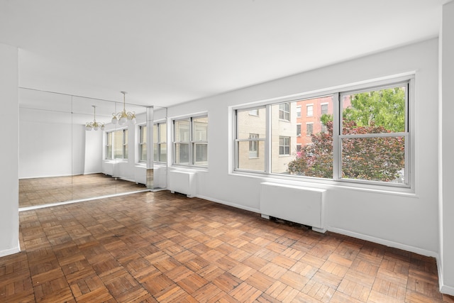 20 E 9th St Unit 2X, New York City, NY 10003 - spare room with radiator and a chandelier