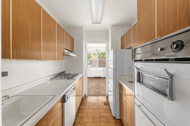20 E 9th St Unit 2X, New York City, NY 10003 - kitchen featuring white appliances, light countertops, and under cabinet range hood