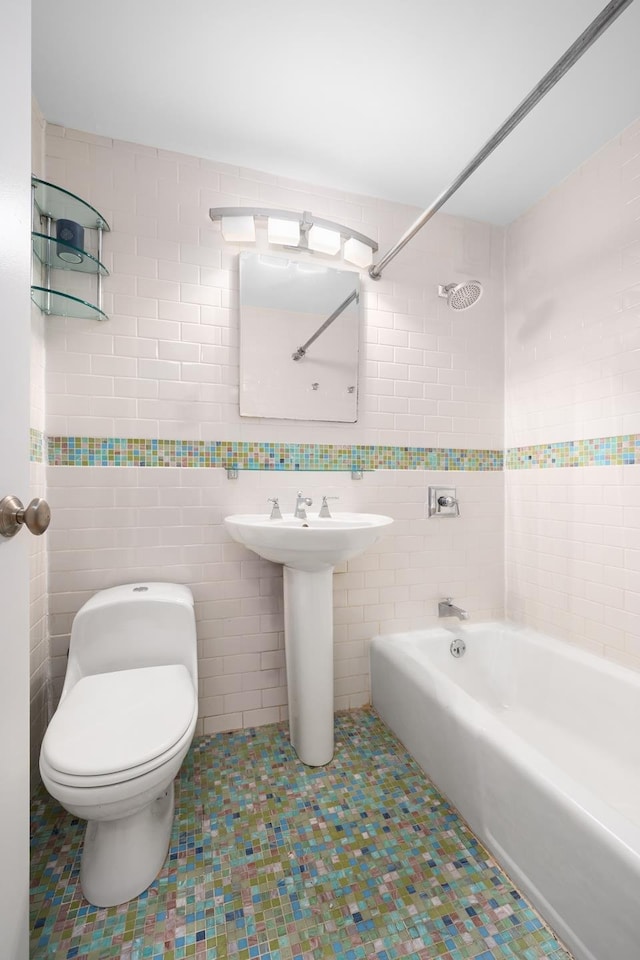 211 Thompson St Unit Lb, New York City, NY 10012 - bathroom featuring toilet,  shower combination, and tile walls
