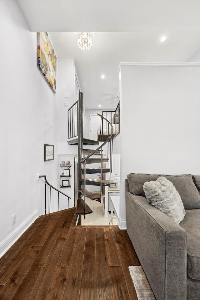 211 Thompson St Unit Lb, New York City, NY 10012 - staircase featuring recessed lighting, a chandelier, wood finished floors, and baseboards