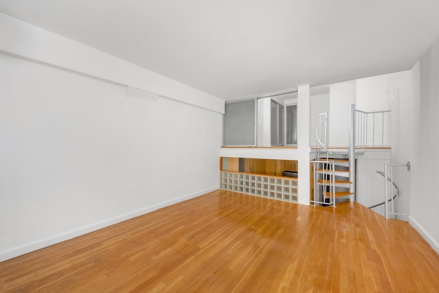 211 Thompson St Unit Lb, New York City, NY 10012 - unfurnished living room with baseboards and wood finished floors