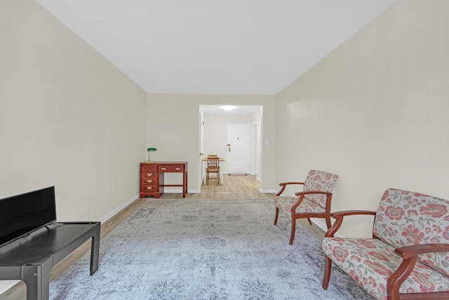 living area with wood finished floors and baseboards