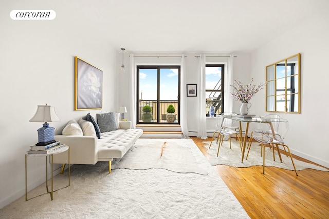 living room with baseboards, wood finished floors, and visible vents