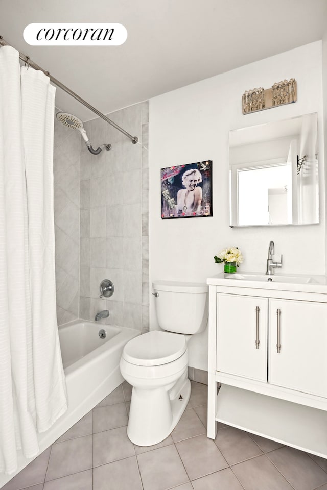 bathroom with tile patterned floors, toilet, baseboards, shower / tub combo, and vanity