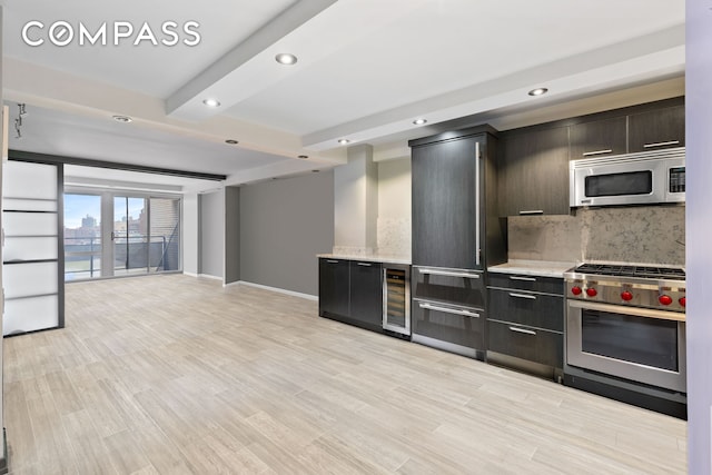 kitchen with appliances with stainless steel finishes, tasteful backsplash, wine cooler, modern cabinets, and recessed lighting