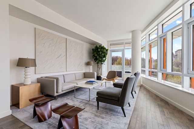 interior space featuring wood-type flooring and baseboards