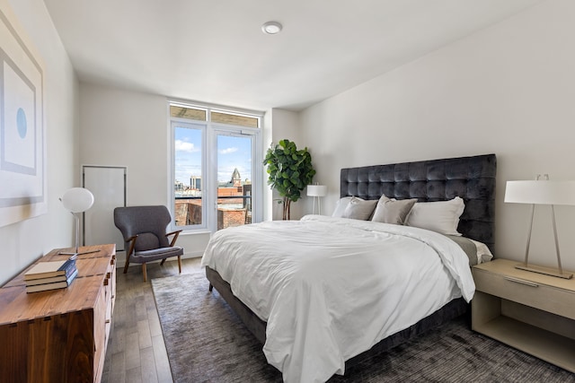 bedroom with dark wood-type flooring
