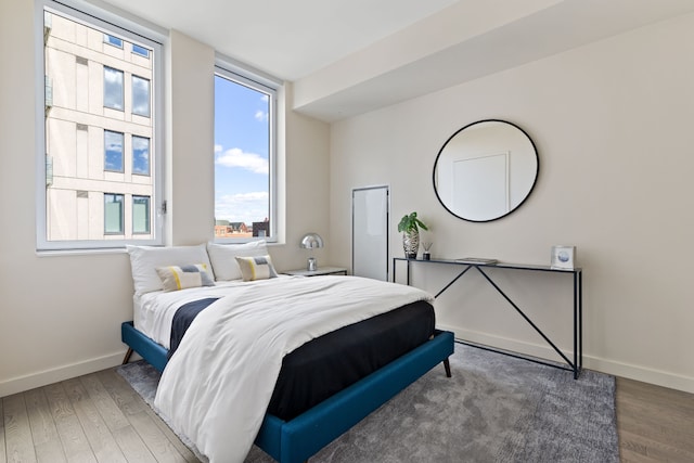 bedroom featuring baseboards and wood finished floors