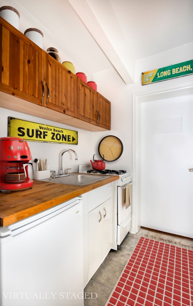 kitchen with white appliances, a sink, and white cabinets
