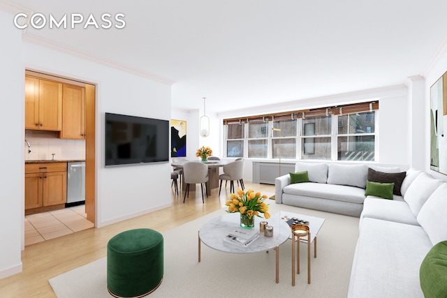 living room with baseboards, ornamental molding, and light wood finished floors