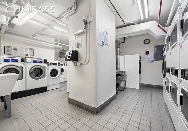 251 E 32nd St Unit 2A, New York City, NY 10016 - shared laundry featuring stacked washer / dryer, washer and clothes dryer, and tile patterned floors