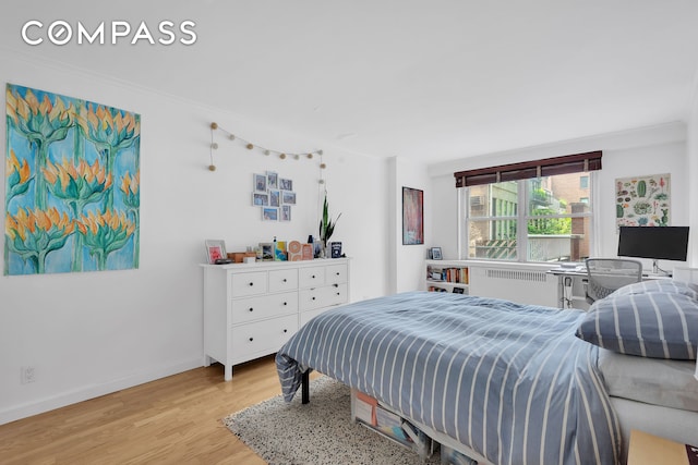 251 E 32nd St Unit 2A, New York City, NY 10016 - bedroom featuring radiator, light wood-style flooring, baseboards, and ornamental molding