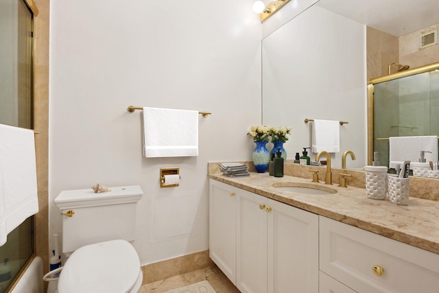 bathroom with a shower with door, toilet, vanity, tile patterned flooring, and baseboards