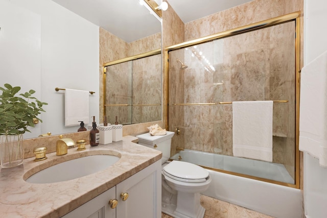 full bathroom with combined bath / shower with glass door, toilet, and vanity