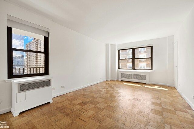 165 W End Ave Unit 17M, New York City, NY 10023 - unfurnished room featuring radiator heating unit and baseboards