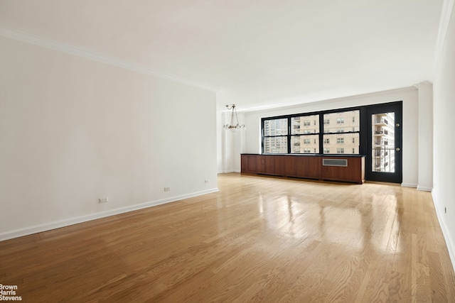 165 W End Ave Unit 17M, New York City, NY 10023 - empty room with a chandelier, light wood-style flooring, baseboards, and ornamental molding