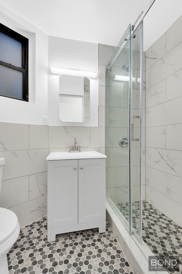 418 E 83rd St Unit 3C, New York City, NY 10028 - full bathroom featuring toilet, tile walls, a stall shower, and vanity