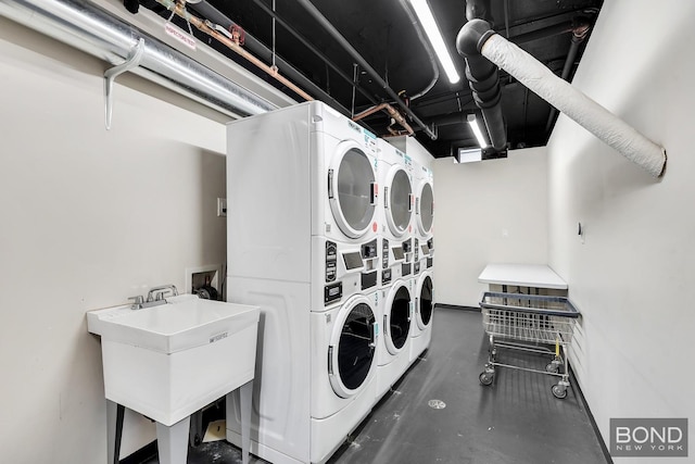 418 E 83rd St Unit 3C, New York City, NY 10028 - shared laundry with stacked washing machine and dryer, independent washer and dryer, and baseboards